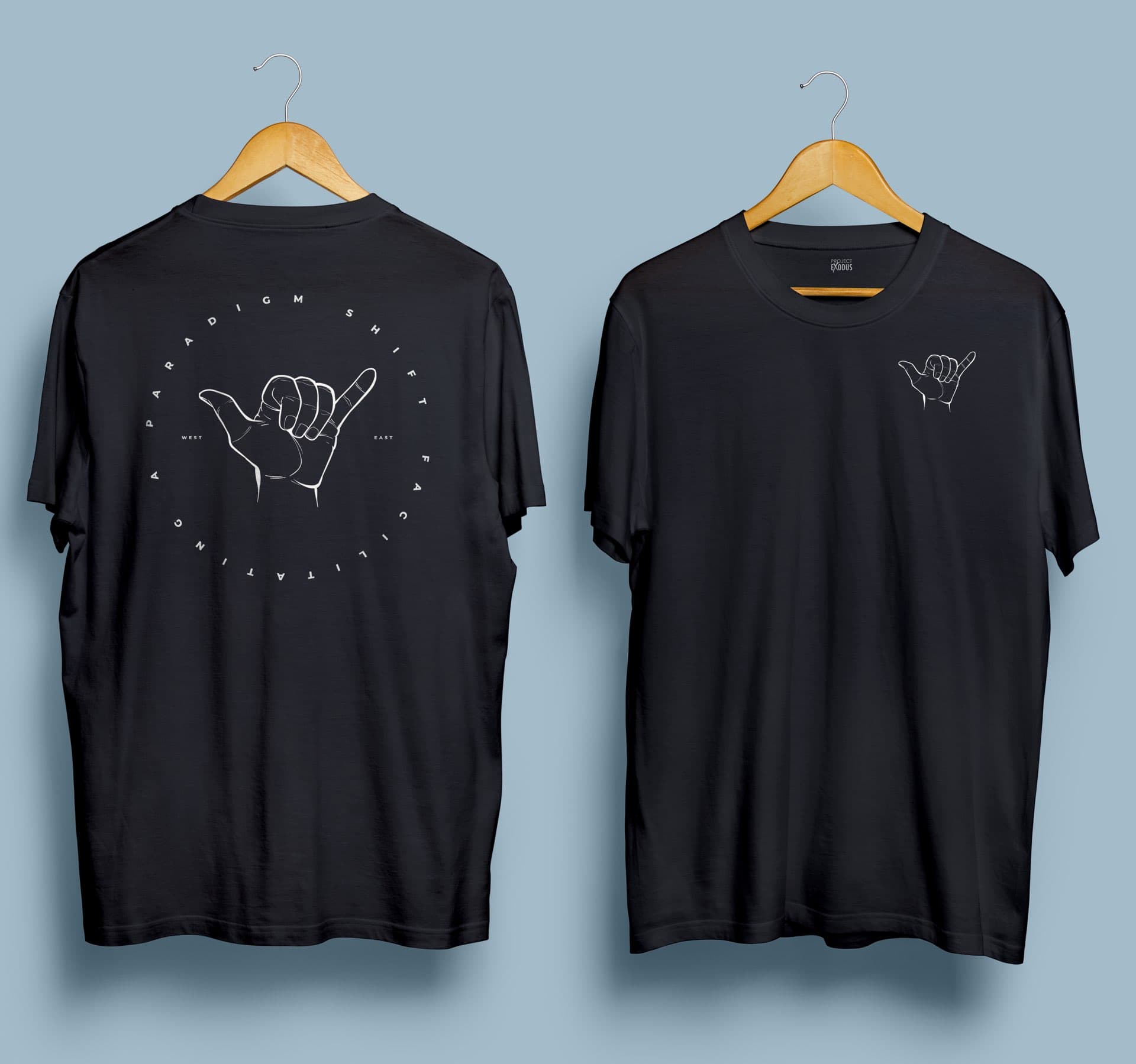 Black tee, front and back: a line-drawn hand inside a ring reading facilitating a paradigm shift