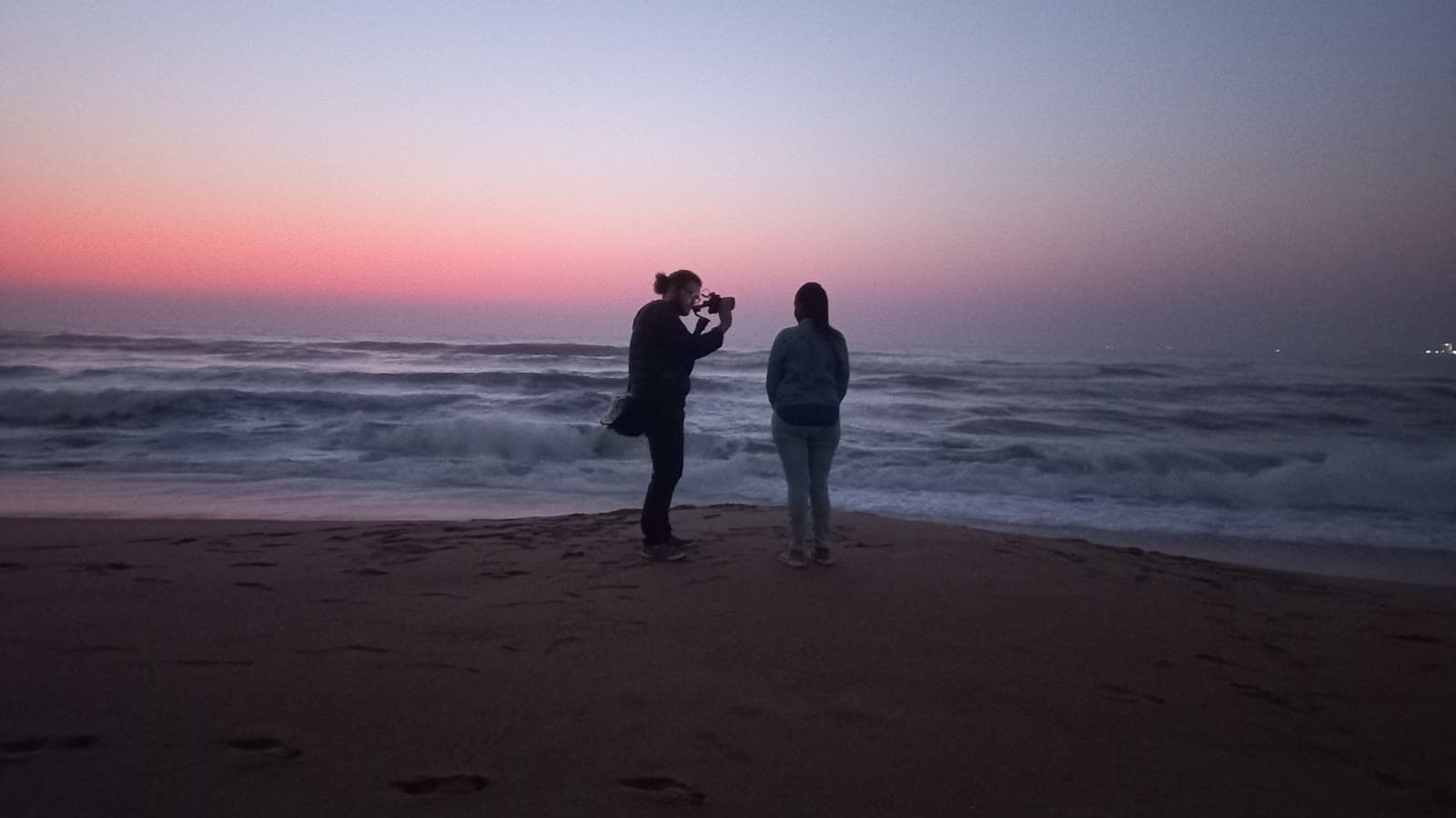Filming a subject on the beach before sunrise