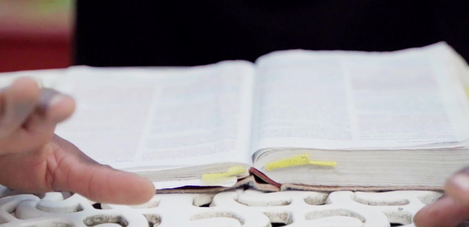 Hands resting on an open book